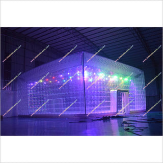 Inflatable dome tent with colorful lights inside, on a white background