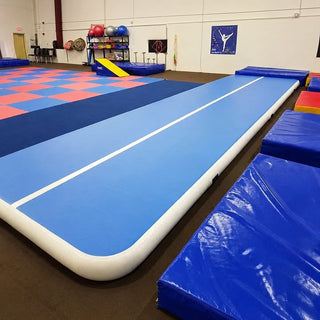 Blue inflatable gymnastics air track in an indoor gym