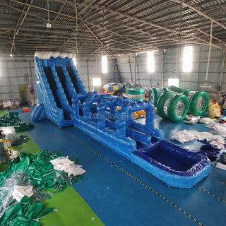 Long blue inflatable water slip and slide in a factory