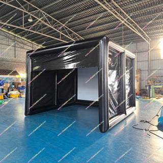 Black inflatable golf simulator enclosure in a factory