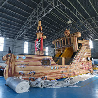 Inflatable pirate ship bounce house slide in a factory
