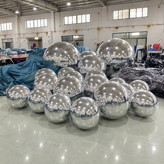 Silver inflatable mirror balls in a factory