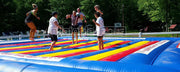 Colorful rainbow large outdoor inflatable jump pad for kids pvc tarpaulin inflatable jump bag